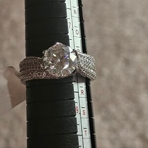 3 ct. Moissanite ring. 3 banded with stones on shank.925 silver